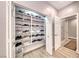 Shoe closet with ample shelving and lighting, providing efficient storage at 3001 Walnut Park Ct, Henderson, NV 89052