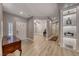 Inviting entryway with light-colored wood floors and white doors adjacent to unique shelving at 3001 Walnut Park Ct, Henderson, NV 89052