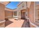 Charming front entrance featuring a sheltered doorway, a bench, and well-maintained landscaping at 3001 Walnut Park Ct, Henderson, NV 89052