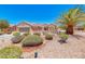 Charming single-story home with well-maintained desert landscaping, mature palm trees, and a two-car garage at 3001 Walnut Park Ct, Henderson, NV 89052