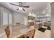 Open kitchen and dining area with ceiling fan, light wood floors, island and stainless steel appliances at 3001 Walnut Park Ct, Henderson, NV 89052