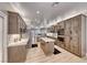 Gourmet kitchen featuring stainless steel appliances, large island, bright countertops and light wood cabinets at 3001 Walnut Park Ct, Henderson, NV 89052