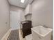Well-lit laundry room with modern appliances and a utility sink, offering convenience and functionality at 3001 Walnut Park Ct, Henderson, NV 89052