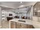 Open-concept living area with stainless steel appliances, an island, leather sofas and plenty of natural light at 3001 Walnut Park Ct, Henderson, NV 89052
