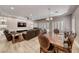 Open-concept living room featuring a fireplace, leather sofas, dining area, and plenty of natural light at 3001 Walnut Park Ct, Henderson, NV 89052