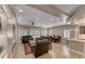 Open-concept living room with large windows, fireplace, custom shelving, and a connected dining area at 3001 Walnut Park Ct, Henderson, NV 89052