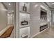 Modern living room with custom shelving, fireplace, and light wood flooring for a bright living space at 3001 Walnut Park Ct, Henderson, NV 89052