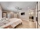 Relaxing main bedroom with a ceiling fan, TV and open bathroom with glass door at 3001 Walnut Park Ct, Henderson, NV 89052