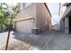 Exterior view of two car garage featuring brick accents, desert landscaping, and gated access at 3553 Judson Ave, Las Vegas, NV 89115