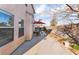 Backyard view featuring a concrete patio, a brick wall, an outdoor dining table and a desert landscape at 4542 Silver Bit Ct, North Las Vegas, NV 89032