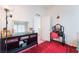 Bright bedroom showcasing a vanity table, mirror, and an area rug with bright light from a window at 4542 Silver Bit Ct, North Las Vegas, NV 89032