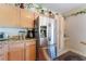Stainless steel refrigerator with light wood cabinets and granite countertops at 4542 Silver Bit Ct, North Las Vegas, NV 89032