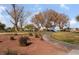 Community park with playground, covered seating, mature trees, green grass, and sidewalks on a sunny day at 4542 Silver Bit Ct, North Las Vegas, NV 89032