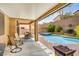 Inviting backyard oasis featuring a sparkling pool, spa, covered patio, and a cozy fire pit, perfect for outdoor entertaining at 7013 Bisoni St, Las Vegas, NV 89149