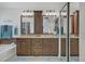Bright bathroom with double sinks, granite countertops, and large soaking tub at 7013 Bisoni St, Las Vegas, NV 89149