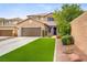 Beautiful two-story home with a well-manicured lawn, attached two-car garage, and welcoming curb appeal at 7013 Bisoni St, Las Vegas, NV 89149
