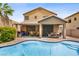 Backyard view of a pool and spa area, and covered patio area of the home at 7013 Bisoni St, Las Vegas, NV 89149