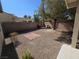 Low maintenance backyard with decorative rock, brick accents, and lush landscaping at 7572 Coyote Cave Ave, Las Vegas, NV 89113