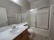 Bathroom featuring a vanity with sink and framed sliding glass door shower and tub at 7572 Coyote Cave Ave, Las Vegas, NV 89113