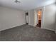 Comfortable bedroom with neutral carpet, recessed lights, and easy access to the bathroom at 7572 Coyote Cave Ave, Las Vegas, NV 89113