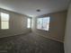 Inviting bedroom featuring neutral paint, carpet flooring, and natural light at 7572 Coyote Cave Ave, Las Vegas, NV 89113