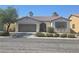 Charming single-story home with a well-maintained front yard and a two-car garage at 7572 Coyote Cave Ave, Las Vegas, NV 89113