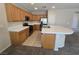 Functional kitchen featuring stainless appliances, plenty of cabinetry, and tile countertops at 7572 Coyote Cave Ave, Las Vegas, NV 89113