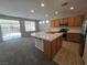 Bright kitchen with stainless steel appliances, tile countertops, and an island sink at 7572 Coyote Cave Ave, Las Vegas, NV 89113
