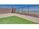 Backyard with synthetic grass, rock landscaping, and block wall at 860 Echelon St, Las Vegas, NV 89138