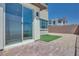 Backyard with stone patio, synthetic grass, and rock landscaping at 860 Echelon St, Las Vegas, NV 89138