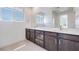 Bright bathroom features double sinks, large mirror, and dark wood vanity at 860 Echelon St, Las Vegas, NV 89138