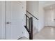 Bright foyer with tile flooring, wooden railing staircase and a white door with brushed metal handle at 860 Echelon St, Las Vegas, NV 89138