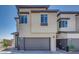 Contemporary home featuring a two-car garage and neutral stucco exterior with dark brown trim at 860 Echelon St, Las Vegas, NV 89138