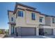 A modern two-story house with a gray garage door, neutral stucco exterior, and manicured landscaping at 860 Echelon St, Las Vegas, NV 89138