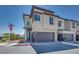 Modern two-story home with a gray garage door, muted exterior, and sidewalk corner view at 860 Echelon St, Las Vegas, NV 89138