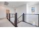 Upstairs hallway with modern railing and carpeted floor at 860 Echelon St, Las Vegas, NV 89138