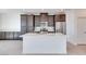 Stylish kitchen featuring a center island, dark cabinets, stainless steel appliances, and tile flooring at 860 Echelon St, Las Vegas, NV 89138
