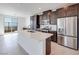 Gourmet kitchen with a central island, stainless appliances, dark cabinetry and bright countertops at 860 Echelon St, Las Vegas, NV 89138
