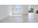 An expansive living room features tile floors, white walls, and a sliding glass door at 860 Echelon St, Las Vegas, NV 89138