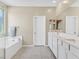 Bright bathroom with double sinks, a large mirror, and a separate soaking tub at 949 Bayberry Ridge St, Henderson, NV 89052