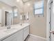 Bright bathroom with double sinks, a large mirror, and a contemporary design at 949 Bayberry Ridge St, Henderson, NV 89052