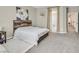 Bedroom featuring a bed with wooden headboard, neutral colors, and a light-filled ambiance at 949 Bayberry Ridge St, Henderson, NV 89052