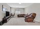 Carpeted bedroom with a desk, TV, and comfortable seating area at 949 Bayberry Ridge St, Henderson, NV 89052