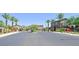 Community entrance featuring gates, desert landscaping, palm trees, and nearby residences at 949 Bayberry Ridge St, Henderson, NV 89052