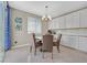 Charming dining area with slider to the patio, featuring a stylish chandelier and bright, airy ambiance at 949 Bayberry Ridge St, Henderson, NV 89052