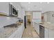 Chef's kitchen featuring white cabinets, granite counters, stainless appliances, and tile backsplash at 949 Bayberry Ridge St, Henderson, NV 89052