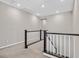 Open landing with carpeted floors and a staircase with white railings at 949 Bayberry Ridge St, Henderson, NV 89052
