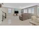 Spacious living room with large windows, tile floors, and comfortable seating at 949 Bayberry Ridge St, Henderson, NV 89052
