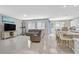 Bright, open-concept living space with tile flooring, seamlessly connecting the living room and kitchen at 949 Bayberry Ridge St, Henderson, NV 89052