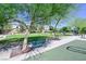 Community park featuring bench seating, green spaces, shade trees, and walking path at 949 Bayberry Ridge St, Henderson, NV 89052